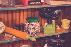 jar of antique marbles and old used kitchen rolling pin    